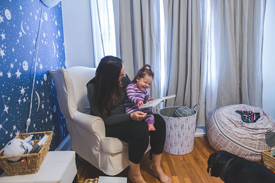 mom reading to daughter in pittsburgh bedroom 