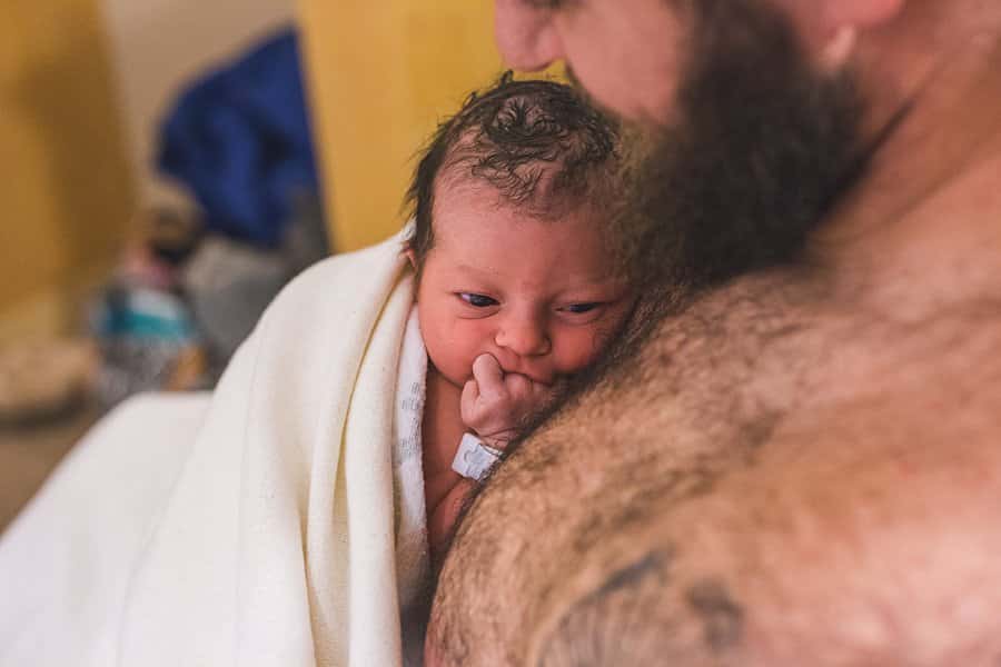 father and newborn baby skin to skin at magee hospital in pittsburgh after birth of baby girl