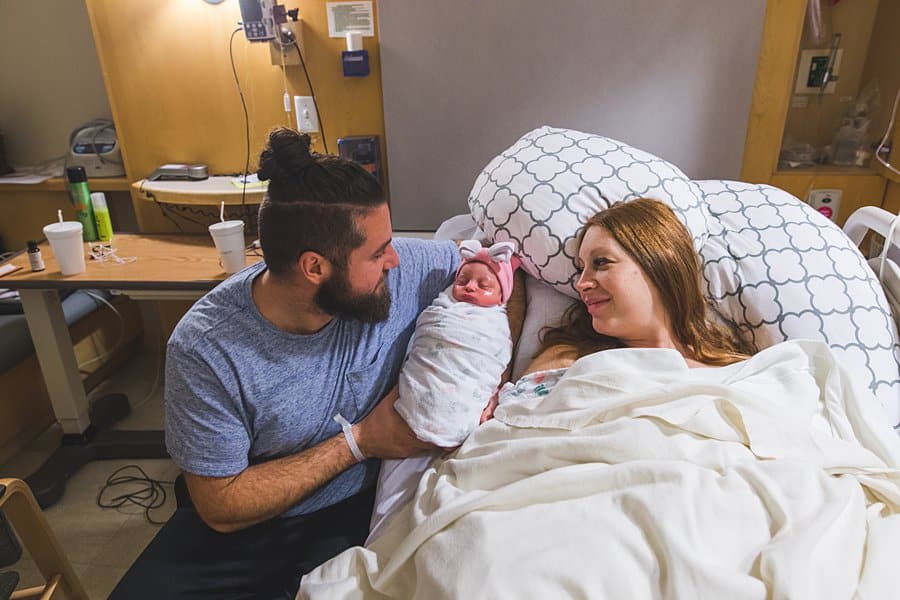 mother father and newborn baby at magee hospital in pittsburgh after birth of baby girl