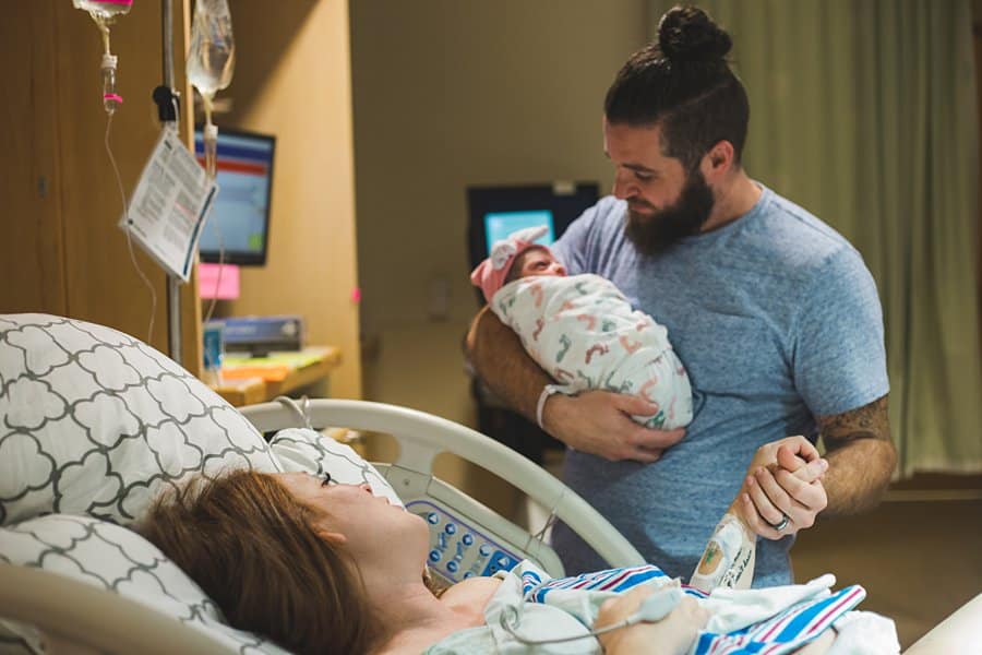 mother father and newborn baby at magee hospital in pittsburgh after birth of baby girl