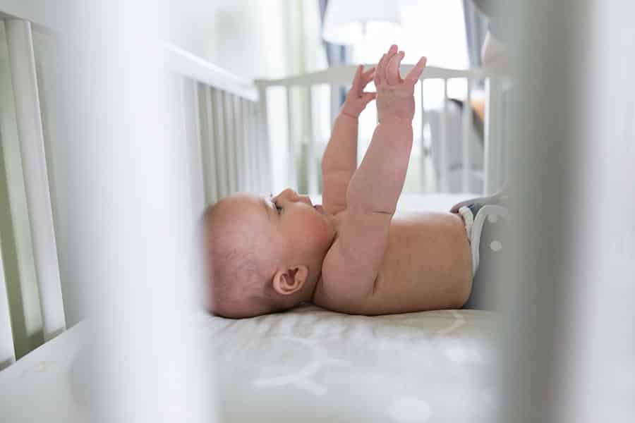 baby in crib for lifestyle newborn session in pittsburgh home
