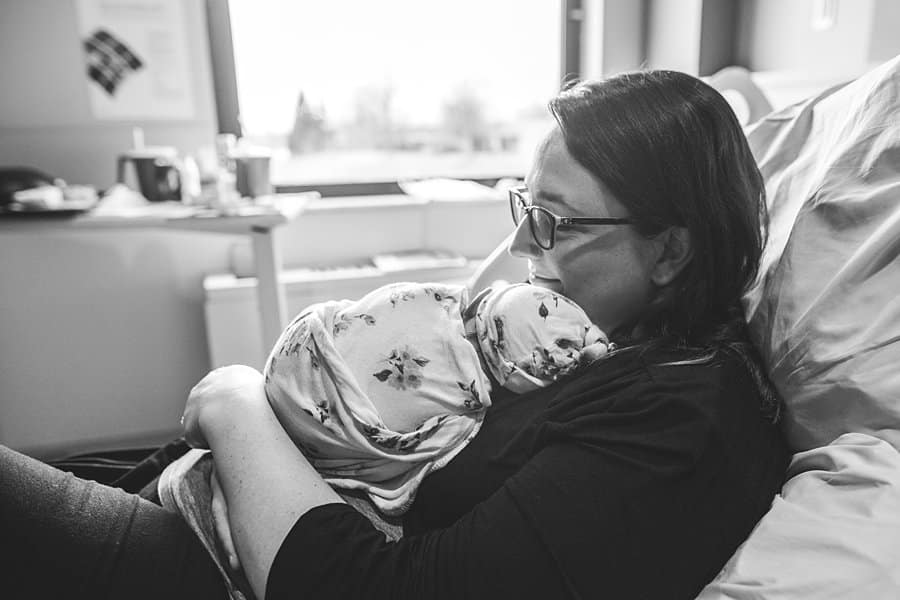 mom with newborn baby on hospital bed in pittsburgh for a fresh 48 session