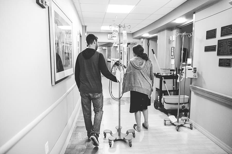 woman in hospital hallway at magee womens hospital with husband during labor 