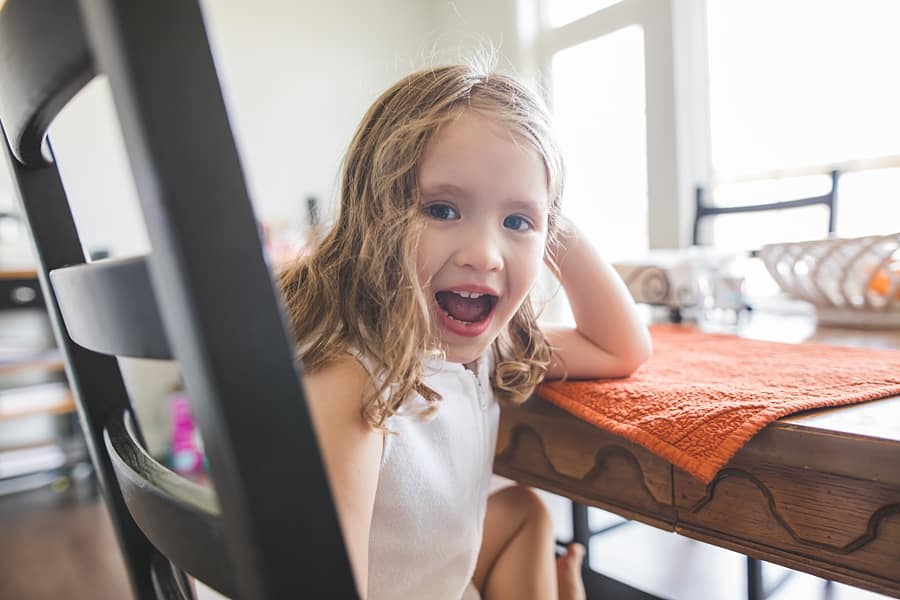 little girl at kitchen table in pittsburgh home for family photo session