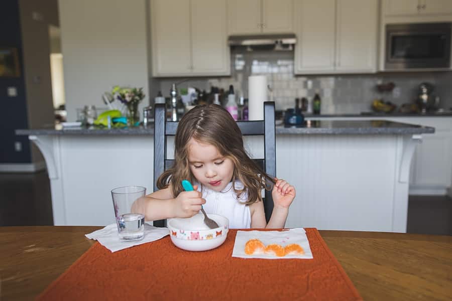little girl at kitchen table in pittsburgh home for family photo session
