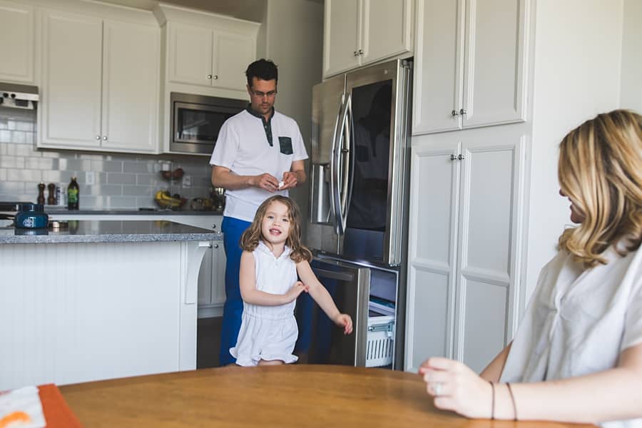 little girl with mom and dad in kitchen of pittsburgh home