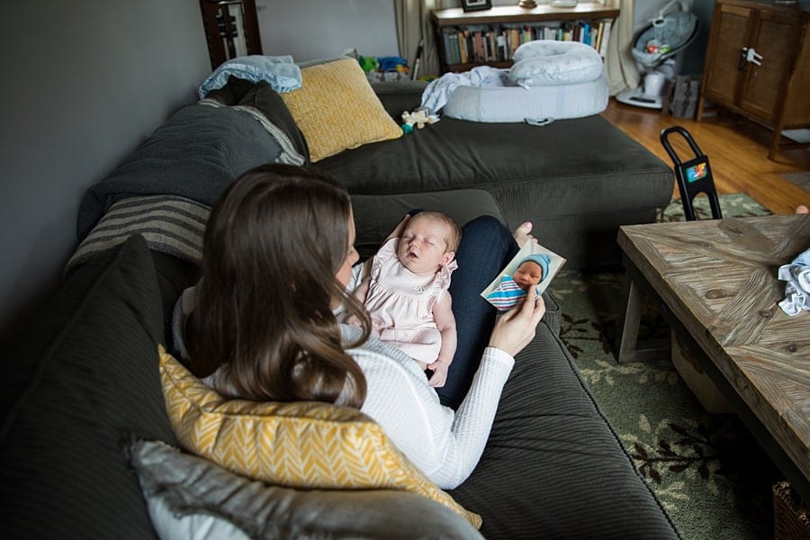 mom with newborn sitting on couch of pittsburgh home for newborn photo session