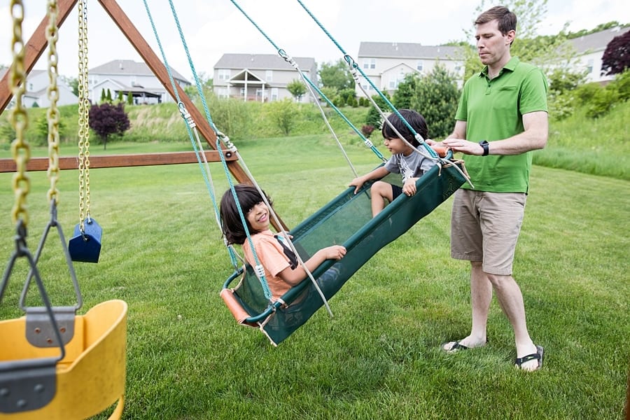 father and sons on swing set of pittsburgh home for family photo session