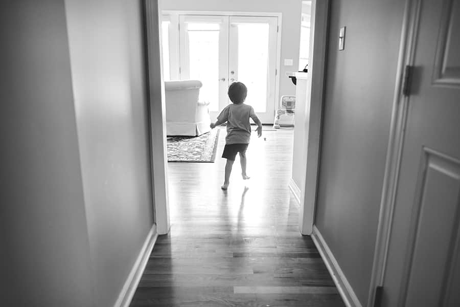 little boy running down hallway