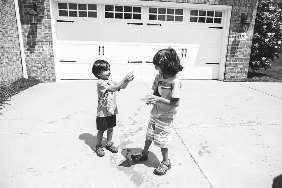 boys playing with water balloons outside of pittsburgh home