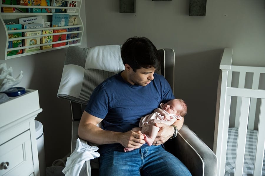dad holding newborn in pittsburgh nursery for newborn photo session
