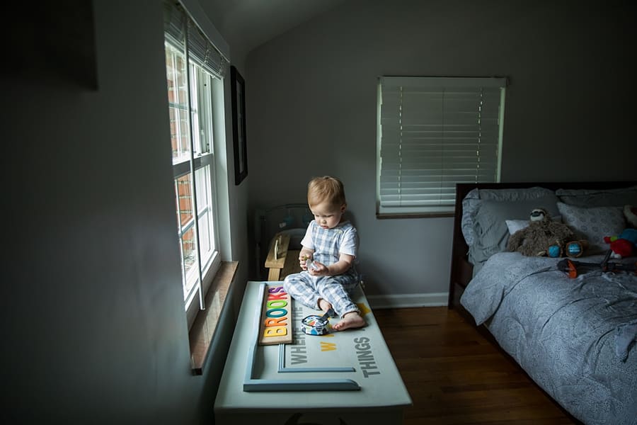 toddler by window light in pittsburgh nursery for photo session