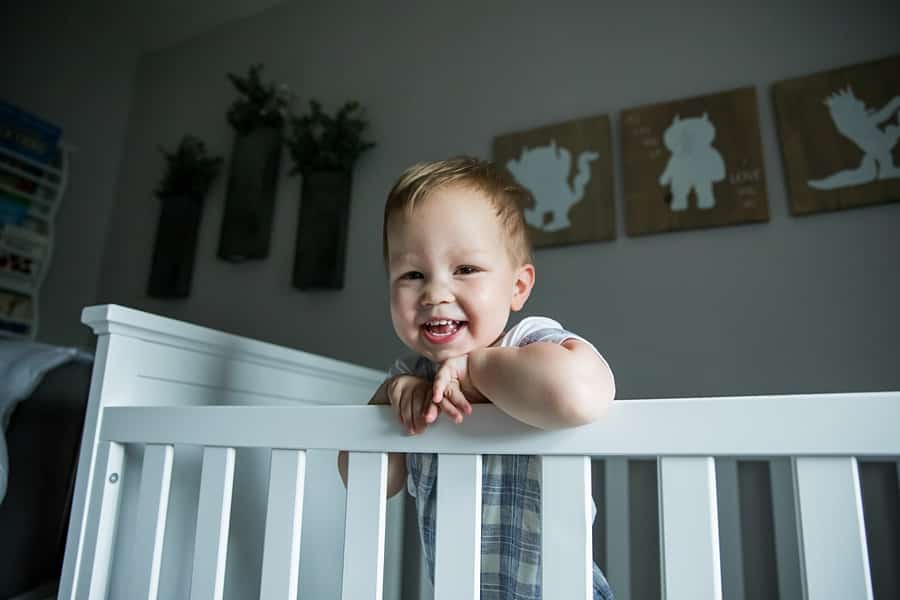 toddler in crib in pittsburgh nursery for photo newborn photo session