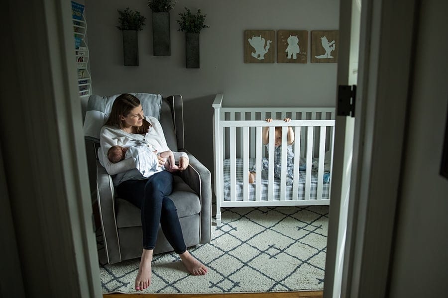 toddler in crib in pittsburgh nursery for for newborn photos with baby Parker