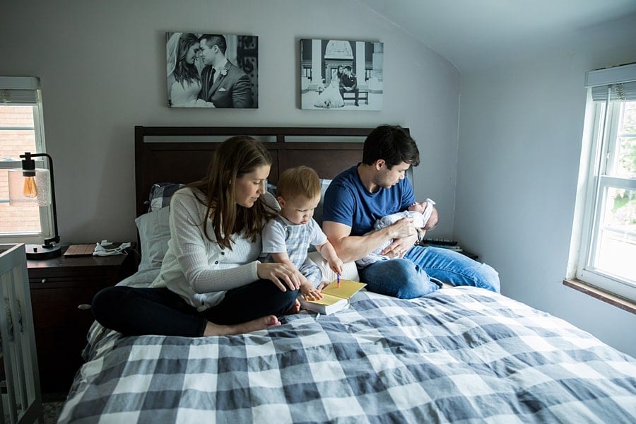 family on bed in pittsburgh home for photo newborn photo session
