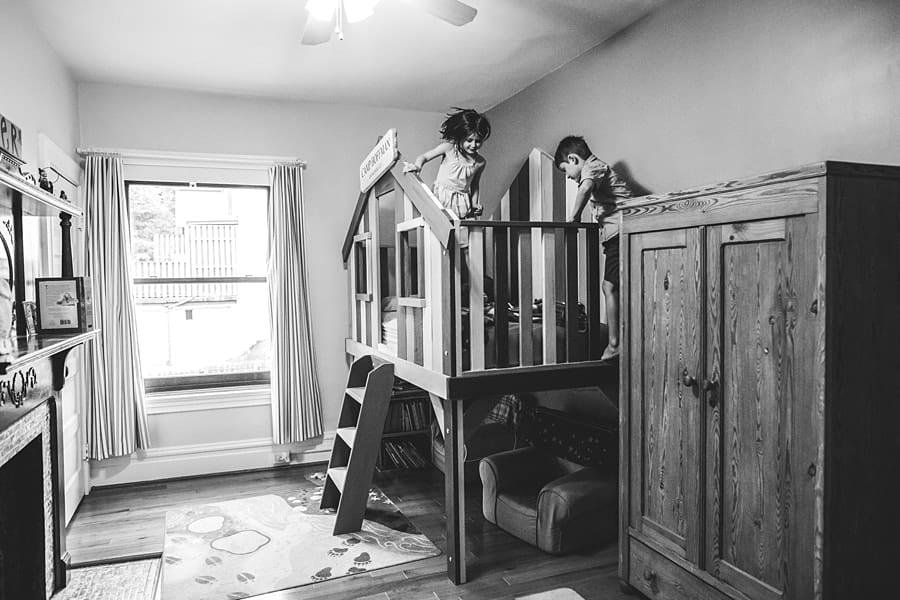brother and sister playing on clubhouse bunkbed