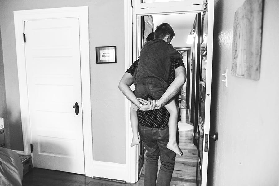 father giving son a piggy back ride out of bedroom
