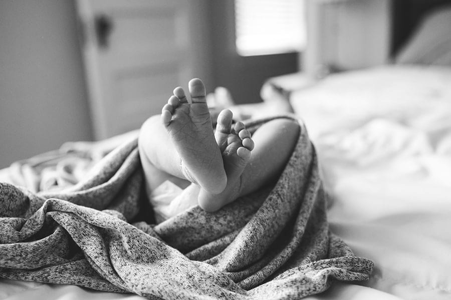 baby feet of newborn baby on bed of pittsburgh home Shadyside Newborn Photographer