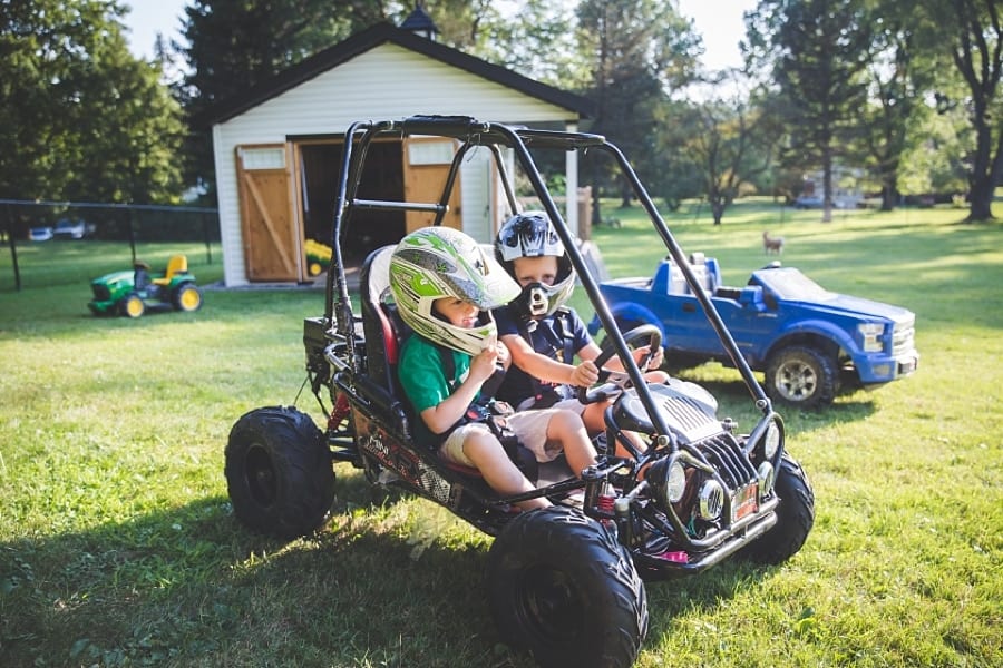 brothers on go cart in backyard of pittsburgh home