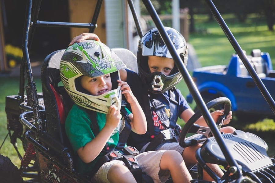 brothers on go cart in backyard of pittsburgh home