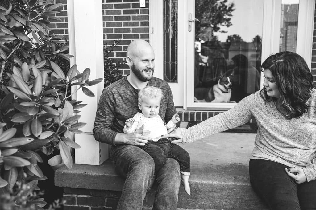 mom dad and daughter on front porch of Family Photos at home in Bridgeville