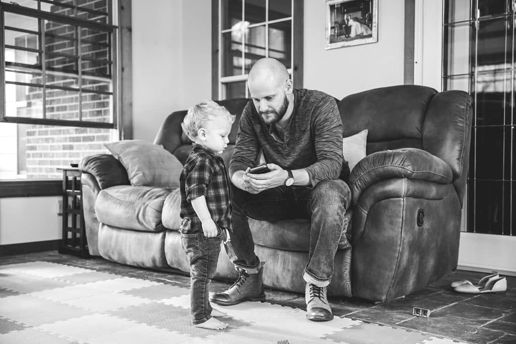 dad and son on couch in living room 