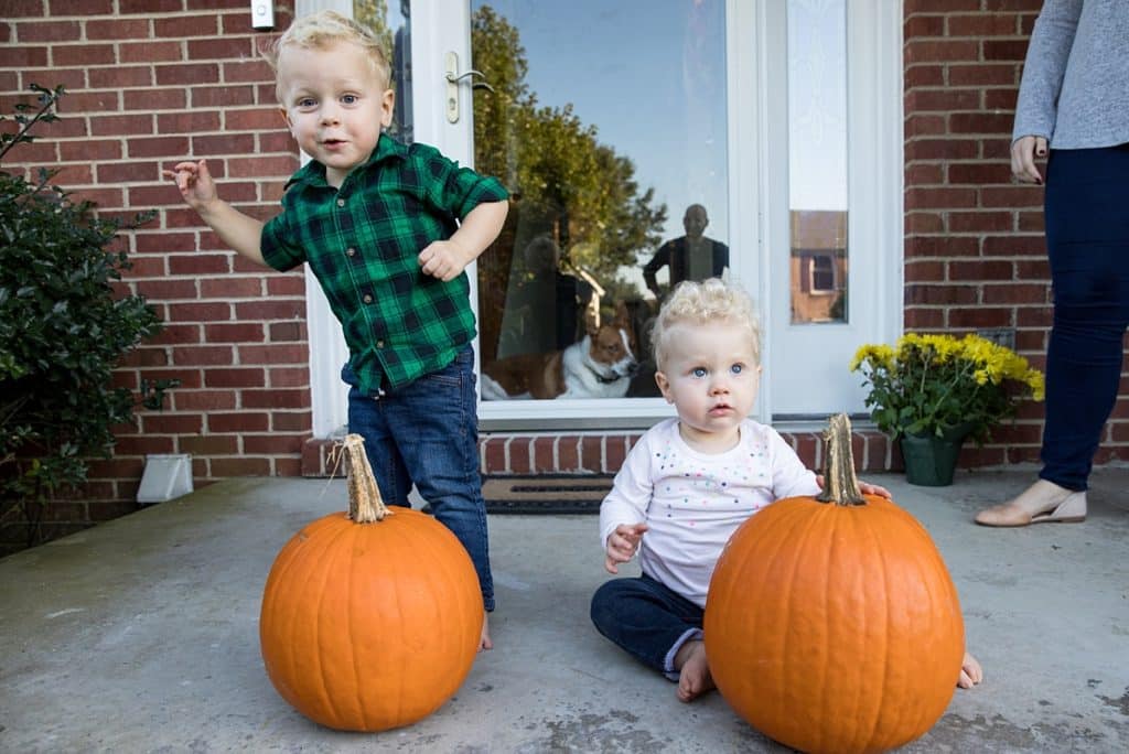 brother and sister on porch with pumpkins Family Photos at home in Bridgeville