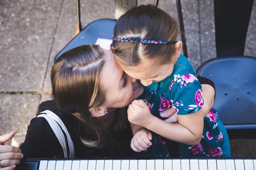 mother and daughter playing outdoor piano at carnegie mellon campus pittsburgh