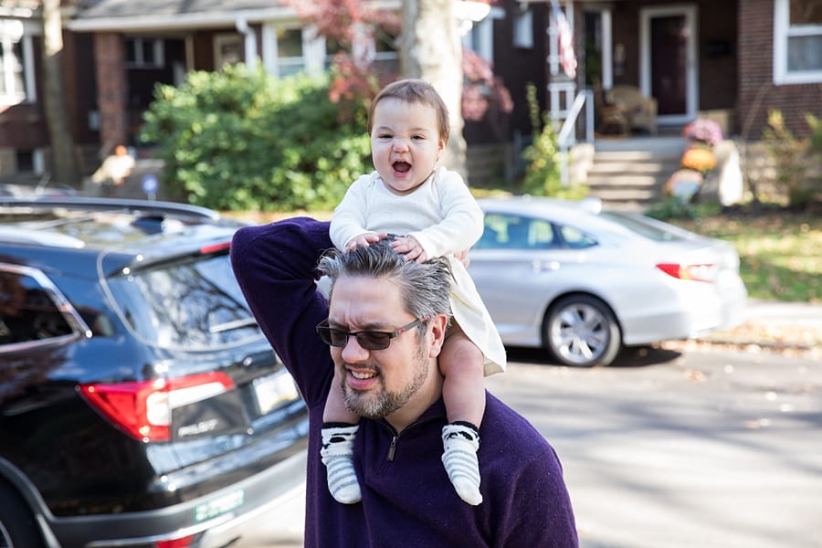 dad and baby on porch for lifestyle family photo session at house in regent square