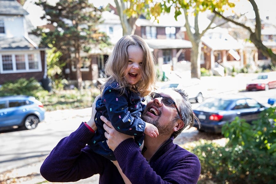 dad and baby on porch for lifestyle family photo session at house in regent square