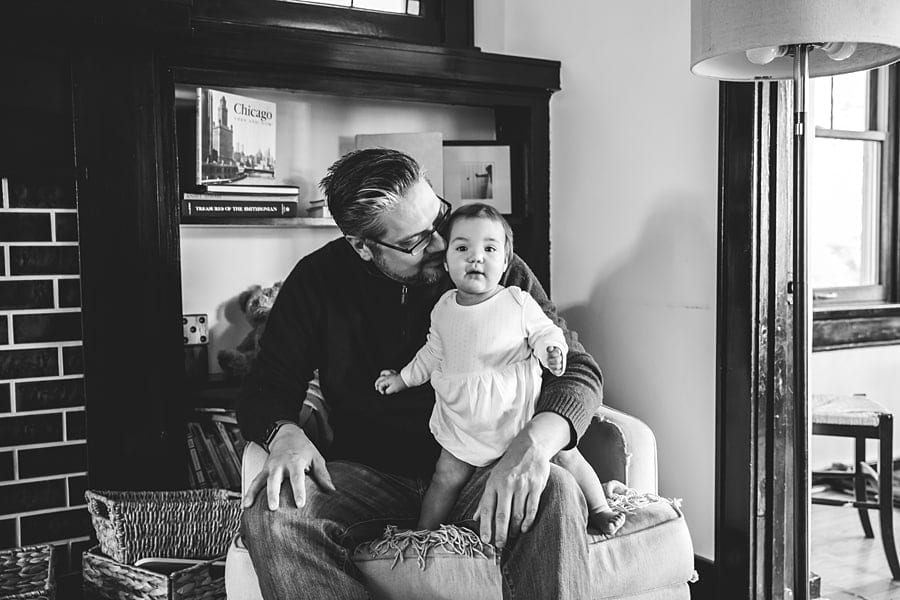 dad and baby on chair in living room documentary family photo session in pittsburgh