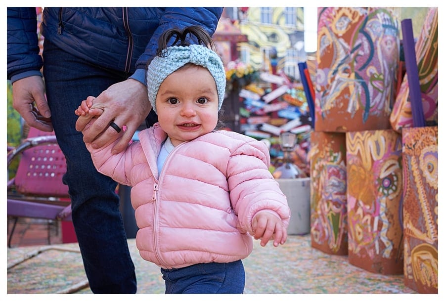 photo session at randlyland with toddler in pink coat