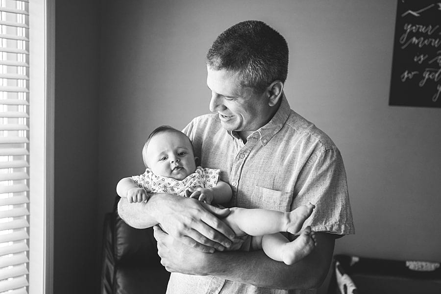 dad holding son in home in pine township pa for photo session dad holding baby son in home in pine township pa for photo session