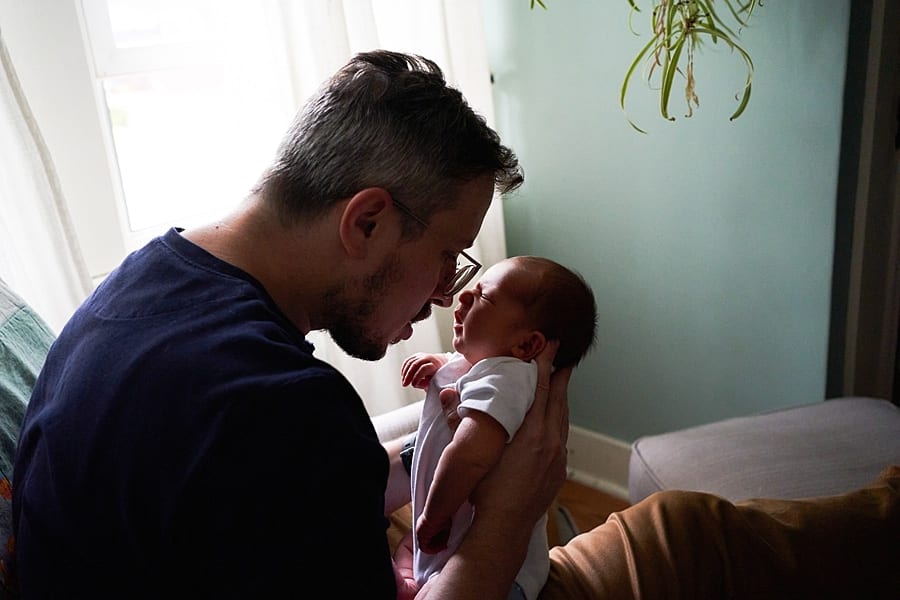 dad nose to nose with newborn son