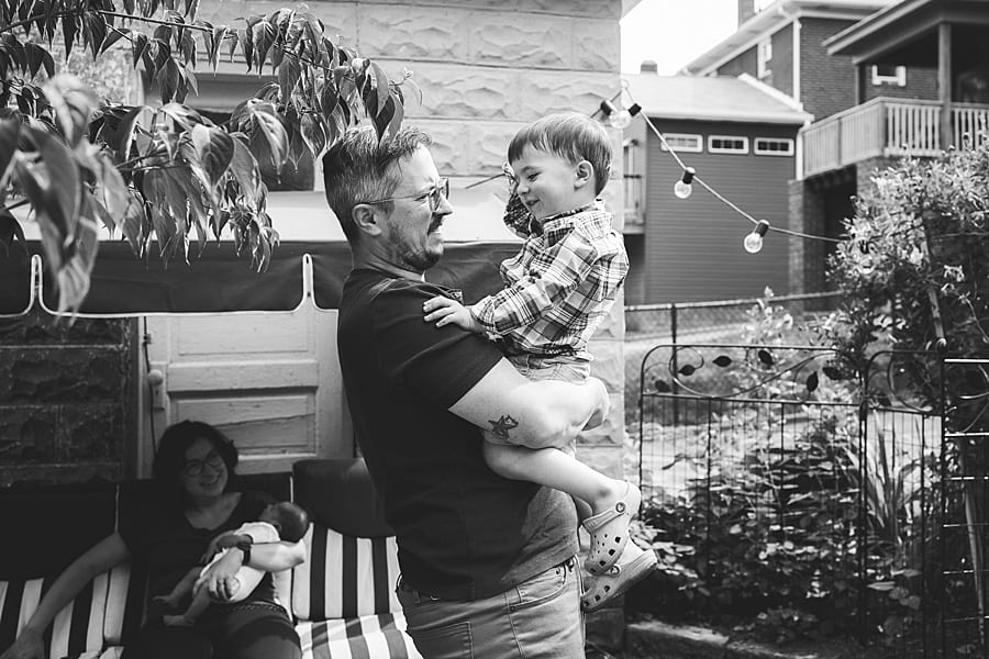 dad holding son in backyard