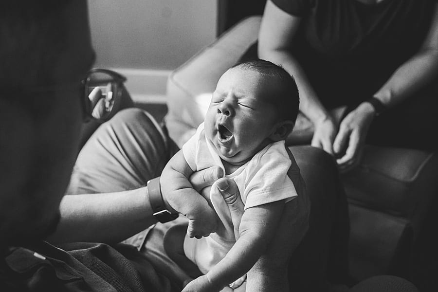 baby boy yawning during newborn photo session with Poland newborn photographer 