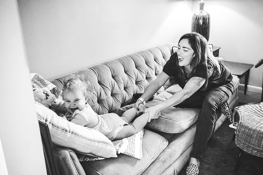 baby girl and mom on couch staying home is not your ordinary family photo session