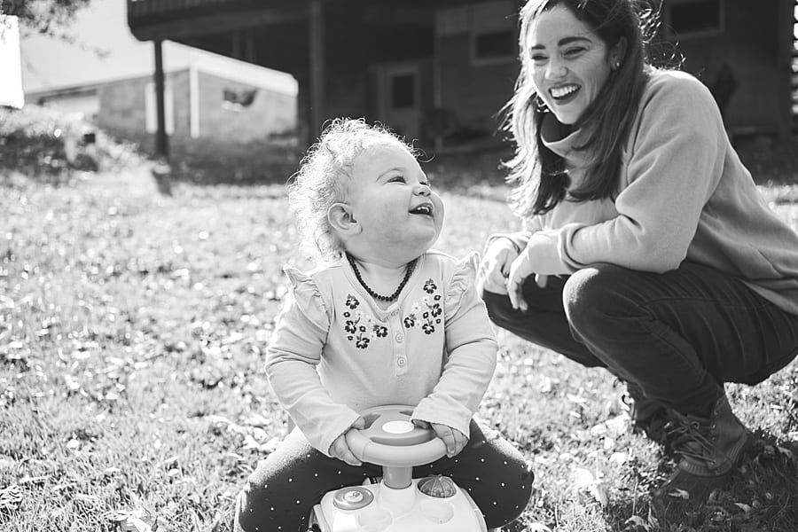 Mother and daughter laughing together in the backyard of their Pittsburgh home