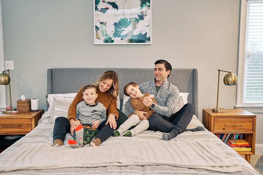 Mom dad and boys on bed for Family Christmas Photos at home | Hampton Township