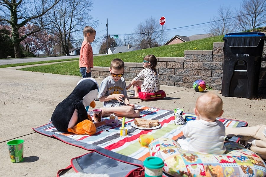 kids in driveway having picnic 20 activities to do during your family session at home