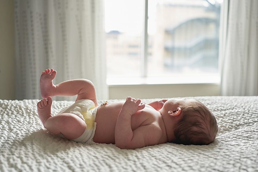 baby girl on bed with window light Mars area newborn baby Photographer