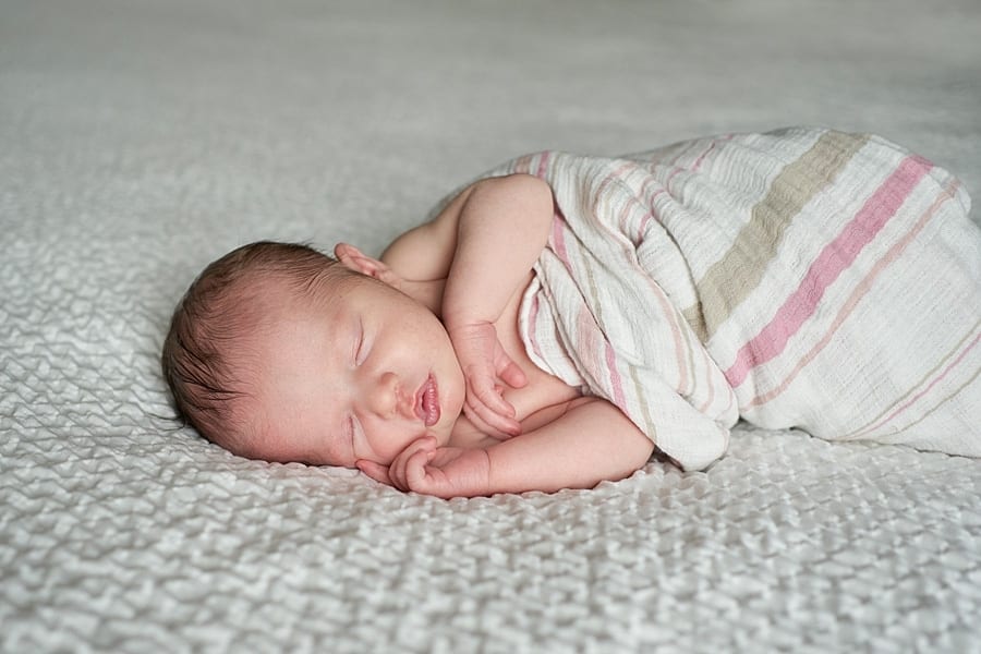 sleeping baby girl on bed with window light Mars baby photographer