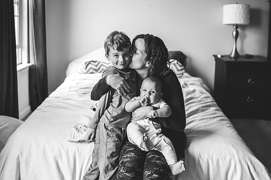 mom with kids on bed inside her Boardman ohio home for a lifestyle family photo session