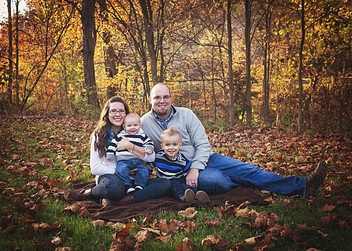 family with fall foliage on the ground at Bradys run park for a family photo session locations for photo sessions in beaver county