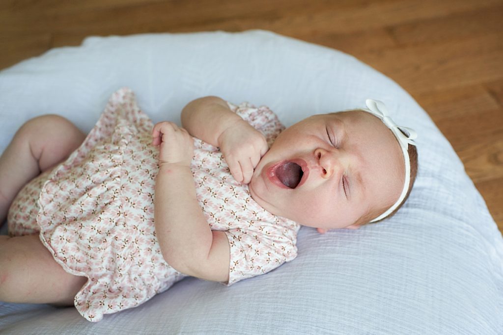 red head newborn baby girl yawning