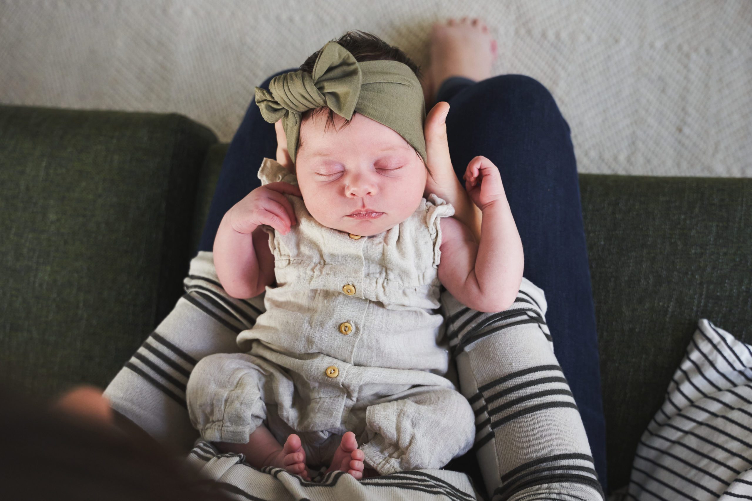 baby newborn girl with bow on her head