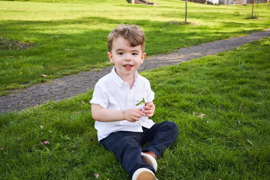 little boy in grass in pittsburgh Mellon park