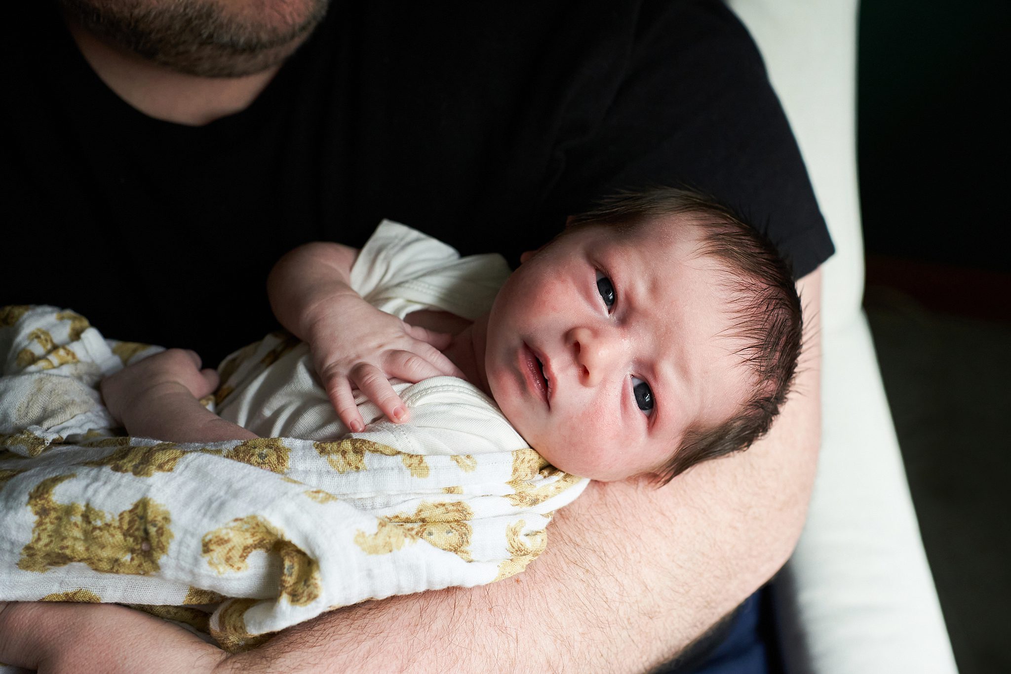 awake newborn baby with golden doodle blanket