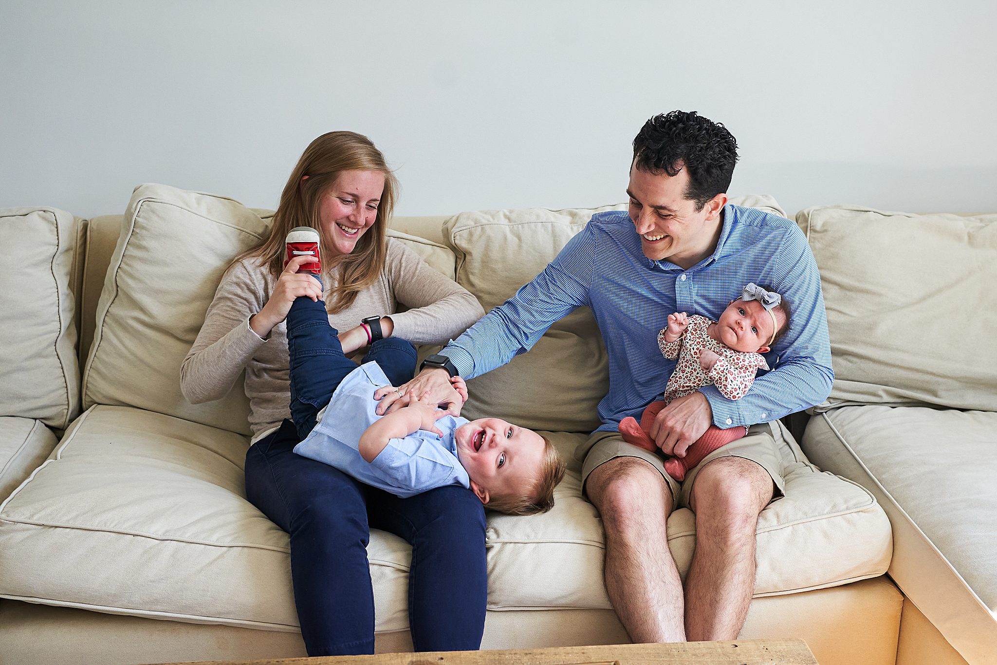 family with baby and toddler on couch newborn photographer in Allison Park