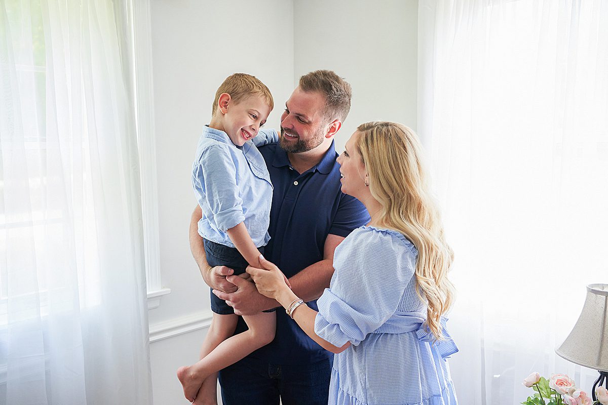 upper saint clair family photo session in home with mom and dad and son in the bedroom 